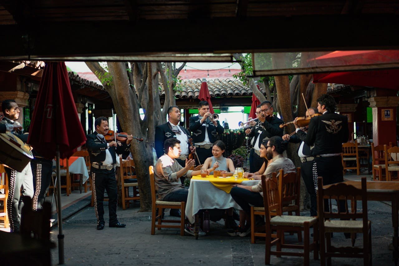 A mariachi band entertains patrons at a vibrant Mexican restaurant. Cultural celebration.